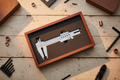 Stainless calipers in cherry box with foam insert on workbench